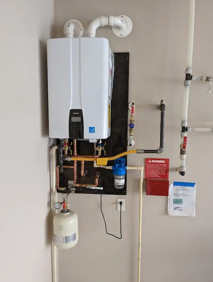 Professional plumber installing copper piping in a Twinsburg home